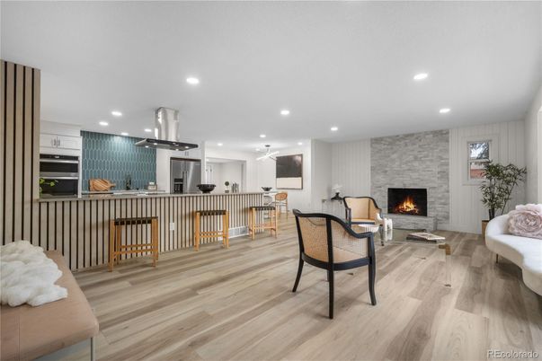 Fireplace, Interior, Kitchen, Living room, Pendant Lights, Recessed Lighting, Stainless Steel Appliances, Stone Walls, Wood Texture Flooring
