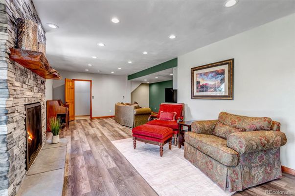 Fireplace, Interior, Living room, Recessed Lighting, Stone Walls, Wood Texture Flooring