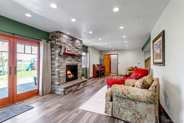 Fireplace, Interior, Living room, Recessed Lighting, Stone Walls, Wood Texture Flooring