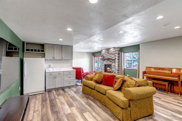 Fireplace, Interior, Living room, Piano, Recessed Lighting, Stone Walls, Wood Texture Flooring