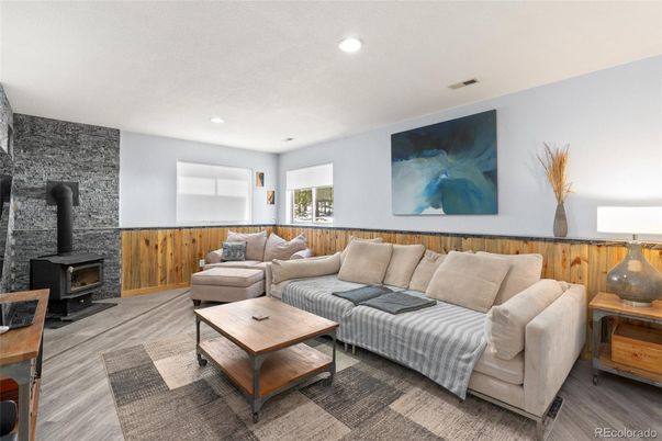 Fireplace, Interior, Living room, Recessed Lighting, Stone Walls, Wood Texture Flooring