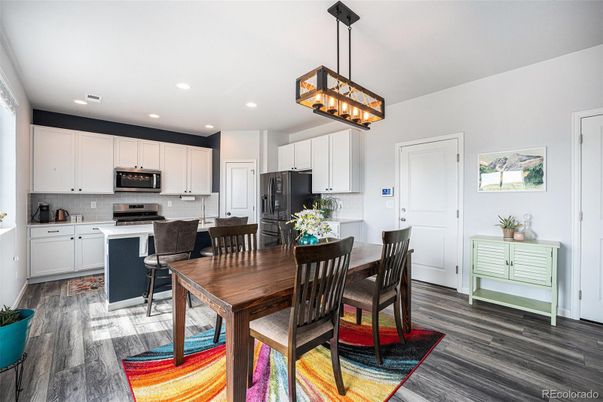 Chandelier, Dining room, Interior, Kitchen, Pendant Lights, Recessed Lighting, Stainless Steel Appliances, Wood Texture Flooring
