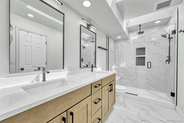 Bathroom, Dual Sink Vanities, Glass Shower, Interior, Marble, Marble Walls, Recessed Lighting