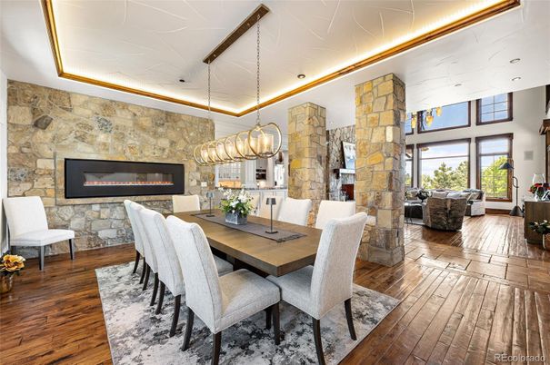 Chandelier, Dining room, Fireplace, Interior, Living room, Pendant Lights, Recessed Lighting, Stone Walls, Wood Texture Flooring