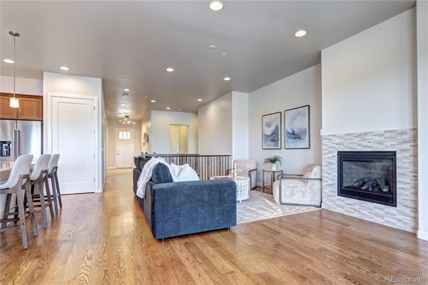 Fireplace, Interior, Kitchen, Living room, Pendant Lights, Recessed Lighting, Stainless Steel Appliances, Wood Texture Flooring