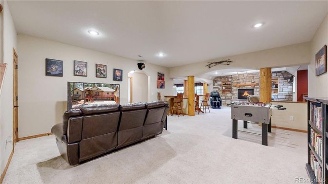 Fireplace, Game Room, Interior, Living room, Recessed Lighting, Stone Walls
