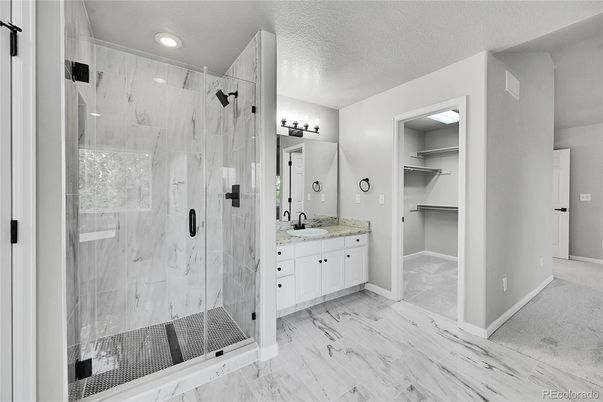 Bathroom, Dual Sink Vanities, Glass Shower, Interior, Marble, Marble Walls, Recessed Lighting, Walk-in Closets