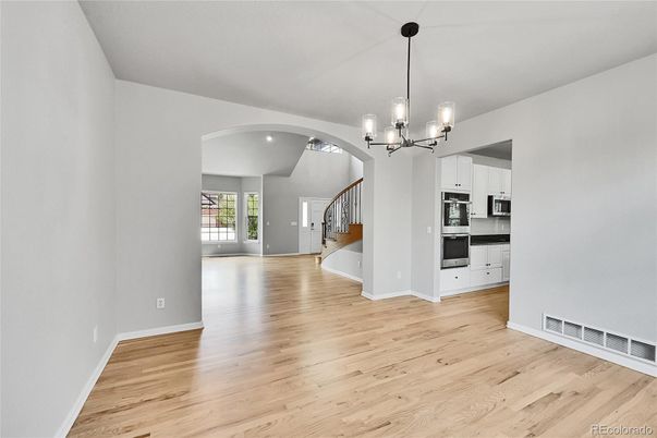 Chandelier, Empty room, Interior, Kitchen, Pendant Lights, Recessed Lighting, Stainless Steel Appliances, Wood Texture Flooring