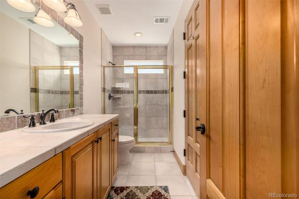 Bathroom, Dual Sink Vanities, Glass Shower, Interior, Recessed Lighting, Tile Countertops