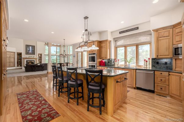Chandelier, Dining room, Fireplace, Interior, Kitchen, Living room, Pendant Lights, Recessed Lighting, Stainless Steel Appliances, Wood Texture Flooring