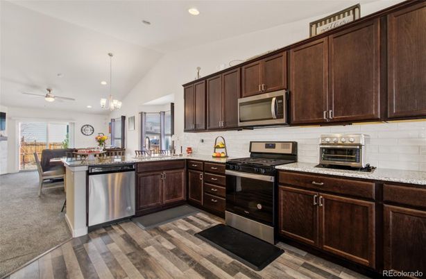 Chandelier, Dining room, Interior, Kitchen, Pendant Lights, Recessed Lighting, Stainless Steel Appliances, Wood Texture Flooring