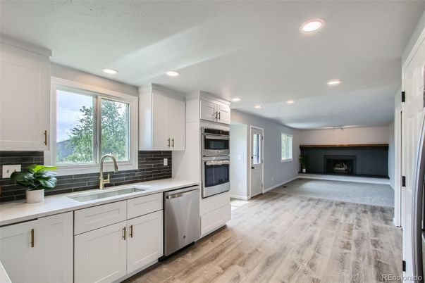 Fireplace, Interior, Kitchen, Recessed Lighting, Stainless Steel Appliances, Wood Texture Flooring