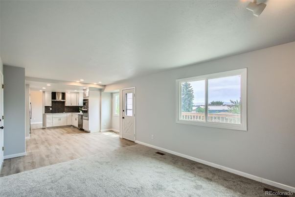 Empty room, Interior, Kitchen, Recessed Lighting, Stainless Steel Appliances, Wood Texture Flooring