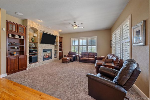 Fireplace, Interior, Living room, Recessed Lighting, Stone Walls, Wood Texture Flooring
