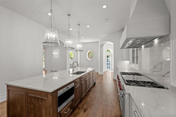 Interior, Kitchen, Marble Walls, Pendant Lights, Recessed Lighting, Stainless Steel Appliances, Wood Texture Flooring