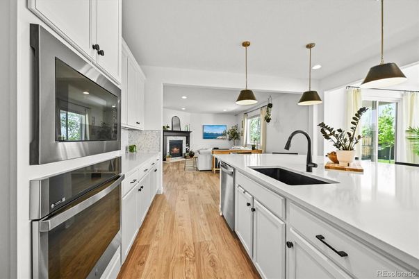 Fireplace, Interior, Kitchen, Pendant Lights, Recessed Lighting, Stainless Steel Appliances, Wood Texture Flooring