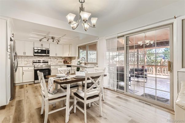 Chandelier, Dining room, Interior, Kitchen, Stainless Steel Appliances, Wood Texture Flooring