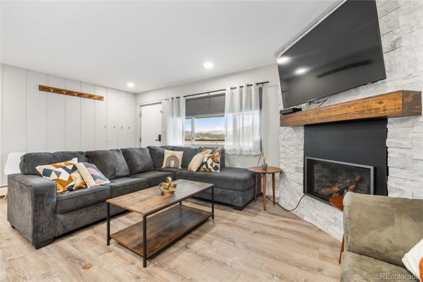 Fireplace, Interior, Living room, Recessed Lighting, Stone Walls, Wood Texture Flooring