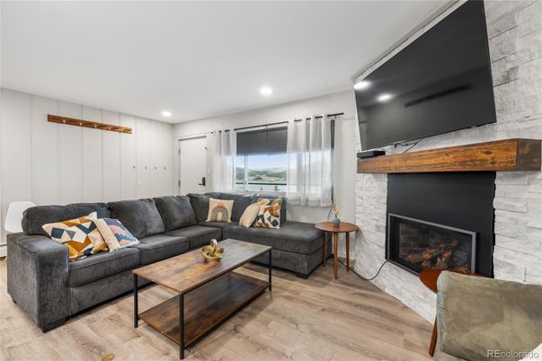 Fireplace, Interior, Living room, Recessed Lighting, Stone Walls, Wood Texture Flooring