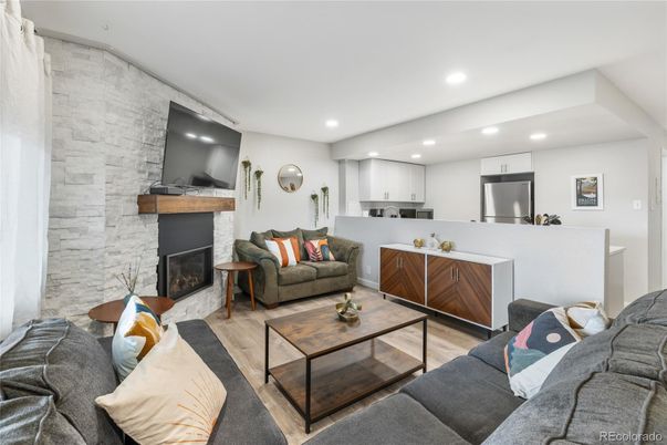 Fireplace, Interior, Kitchen, Living room, Recessed Lighting, Stainless Steel Appliances, Stone Walls, Wood Texture Flooring