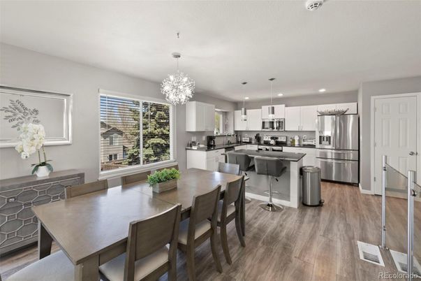 Chandelier, Dining room, Interior, Kitchen, Pendant Lights, Recessed Lighting, Stainless Steel Appliances, Wood Texture Flooring