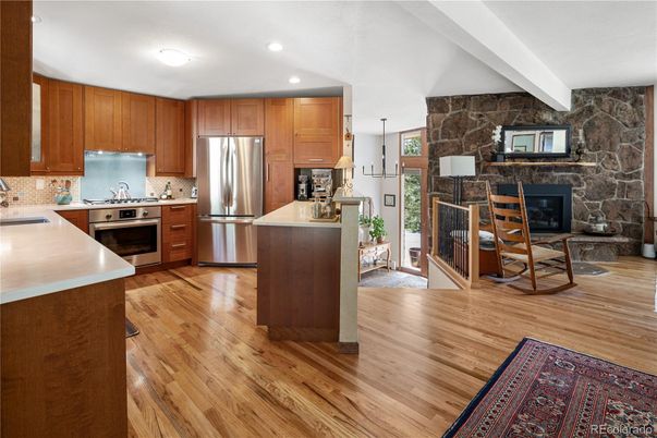 Fireplace, Interior, Kitchen, Recessed Lighting, Stainless Steel Appliances, Stone Walls, Wood Texture Flooring