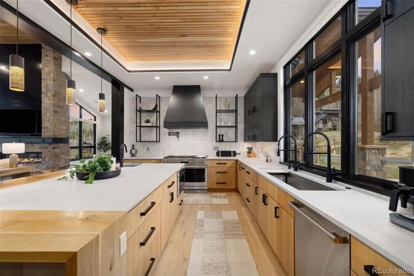 Fireplace, Interior, Kitchen, Pendant Lights, Recessed Lighting, Stainless Steel Appliances, Stone Walls, Wooden Ceilings, Wood Texture Flooring