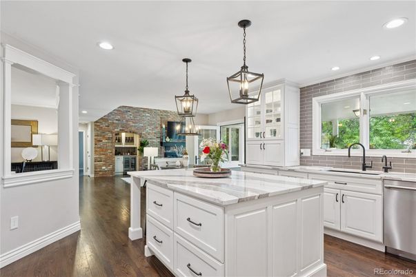 Fireplace, Interior, Kitchen, Pendant Lights, Recessed Lighting, Stainless Steel Appliances, Stone Walls, Wood Texture Flooring