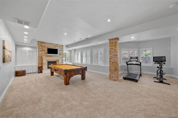 Billiard Table, Fireplace, Fitness Equipment, Game Room, Interior, Recessed Lighting, Stone Walls