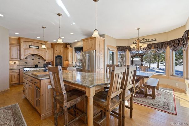 Chandelier, Dining room, Interior, Kitchen, Pendant Lights, Recessed Lighting, Stainless Steel Appliances, Wood Texture Flooring