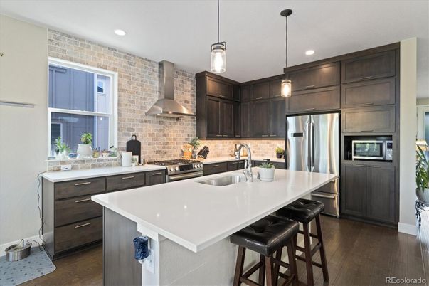 Interior, Kitchen, Pendant Lights, Recessed Lighting, Stainless Steel Appliances, Stone Walls, Wood Texture Flooring