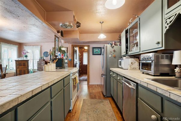 Interior, Kitchen, Pendant Lights, Stainless Steel Appliances, Tile Countertops, Wood Texture Flooring