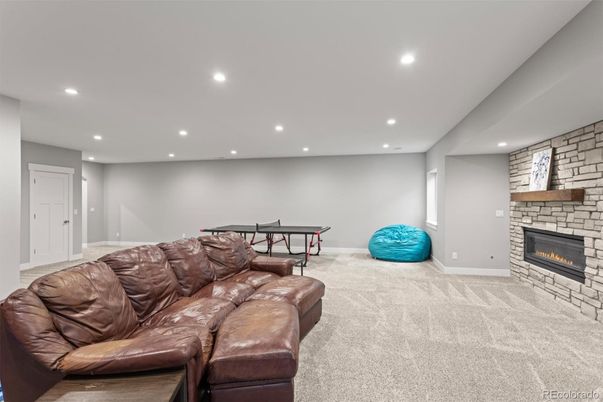 Fireplace, Game Room, Interior, Living room, Recessed Lighting, Stone Walls