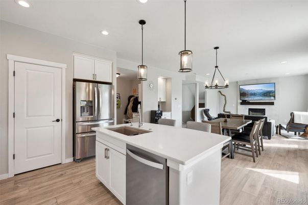 Dining room, Fireplace, Interior, Kitchen, Living room, Pendant Lights, Recessed Lighting, Stainless Steel Appliances, Wood Texture Flooring