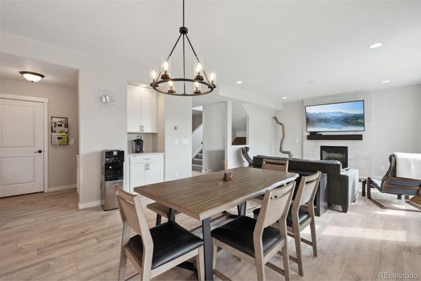 Chandelier, Dining room, Fireplace, Interior, Living room, Pendant Lights, Recessed Lighting, Wood Texture Flooring