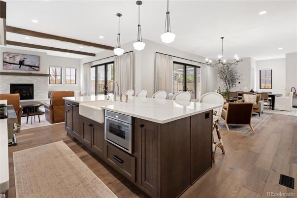 Chandelier, Dining room, Fireplace, Interior, Kitchen, Living room, Pendant Lights, Recessed Lighting, Stainless Steel Appliances, Wooden Beams, Wood Texture Flooring