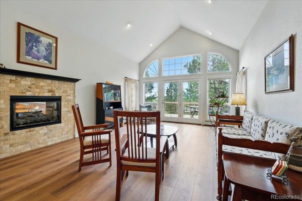Dining room, Fireplace, Interior, Recessed Lighting, Stone Walls, Wood Texture Flooring