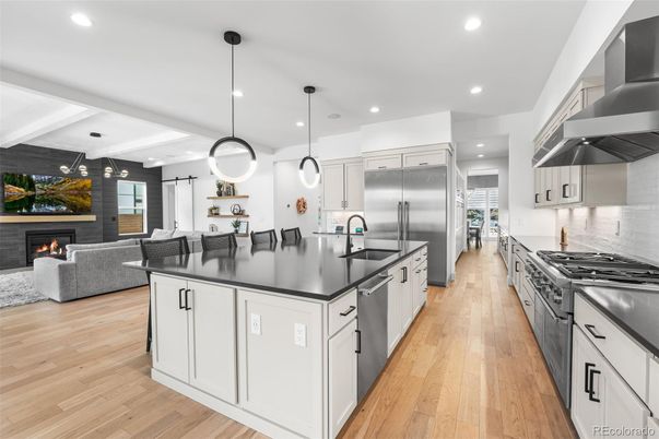 Fireplace, Interior, Kitchen, Living room, Pendant Lights, Recessed Lighting, Stainless Steel Appliances, Wood Texture Flooring