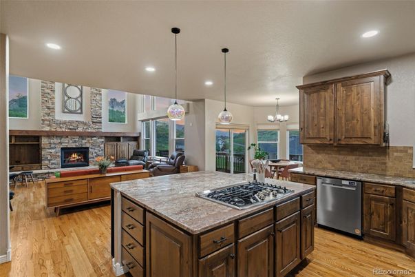 Chandelier, Dining room, Fireplace, Interior, Kitchen, Living room, Pendant Lights, Recessed Lighting, Stone Walls, Wood Texture Flooring