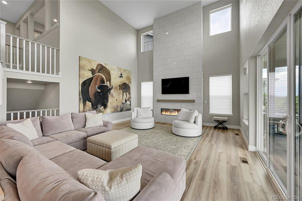 Fireplace, Interior, Living room, Recessed Lighting, Stone Walls, Wood Texture Flooring