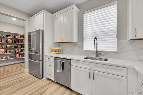 Interior, Kitchen, Marble Walls, Recessed Lighting, Stainless Steel Appliances, Wood Texture Flooring