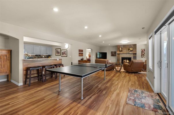 Fireplace, Game Room, Interior, Living room, Recessed Lighting, Wood Texture Flooring