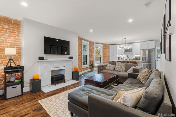 Fireplace, Interior, Kitchen, Living room, Pendant Lights, Recessed Lighting, Stainless Steel Appliances, Stone Walls, Wood Texture Flooring