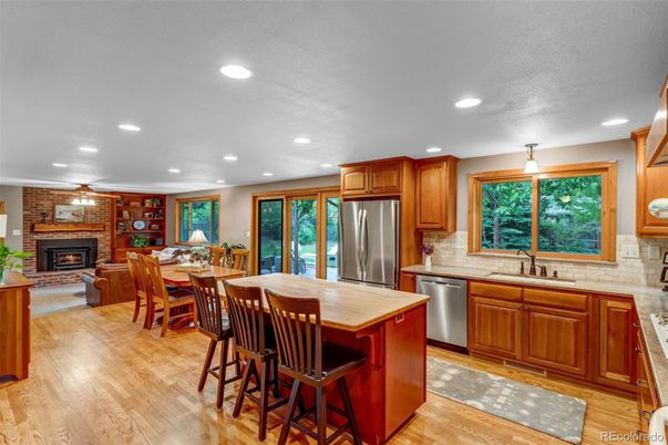 Dining room, Fireplace, Interior, Kitchen, Recessed Lighting, Stainless Steel Appliances, Stone Walls, Wood Texture Flooring