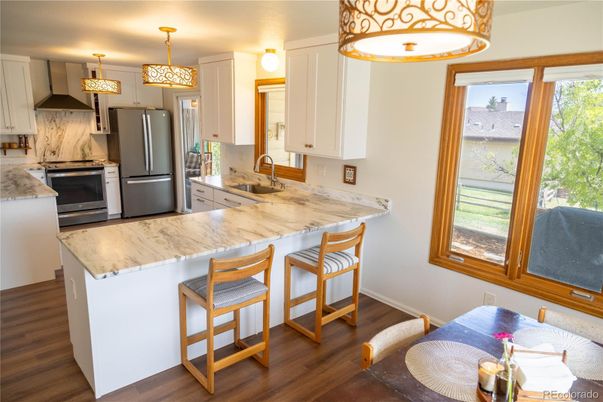 Interior, Kitchen, Marble Walls, Pendant Lights, Stainless Steel Appliances, Wood Texture Flooring