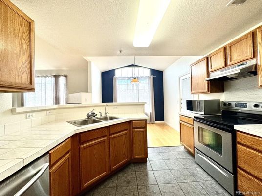 Interior, Kitchen, Pendant Lights, Stainless Steel Appliances, Tile Countertops, Wood Texture Flooring