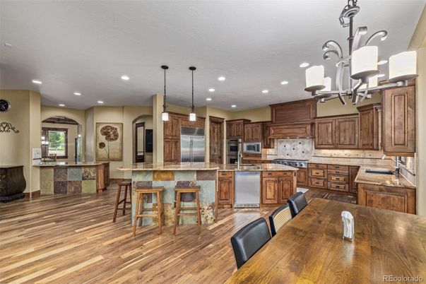 Chandelier, Dining room, Interior, Kitchen, Pendant Lights, Recessed Lighting, Stainless Steel Appliances, Wood Texture Flooring