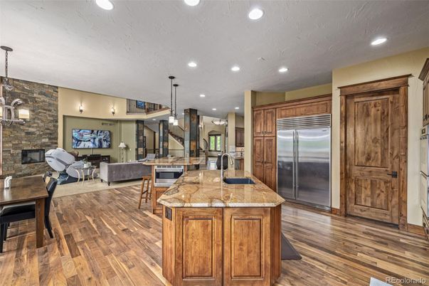 Dining room, Fireplace, Interior, Kitchen, Living room, Pendant Lights, Recessed Lighting, Stainless Steel Appliances, Stone Walls, Wood Texture Flooring