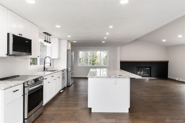 Fireplace, Interior, Kitchen, Pendant Lights, Recessed Lighting, Stainless Steel Appliances, Wood Texture Flooring