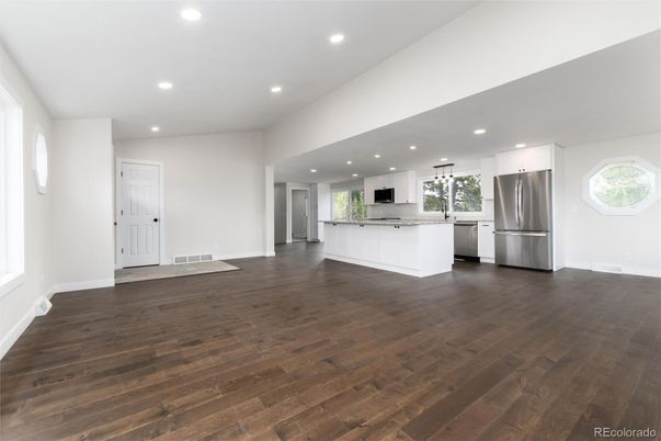 Empty room, Interior, Kitchen, Recessed Lighting, Stainless Steel Appliances, Wood Texture Flooring